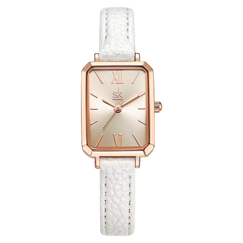 Montre femme SHENGKE rectangulaire, boîtier ton or rose, cadran champagne à chiffres romains, bracelet blanc